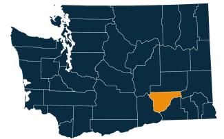 A dark blue map of Washington state with Franklin County highlighted in orange.