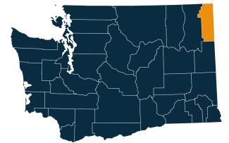 A dark blue map of Washington state with Pend Oreille County highlighted in orange.