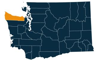 A dark blue map of Washington state with Clallam County highlighted in orange.