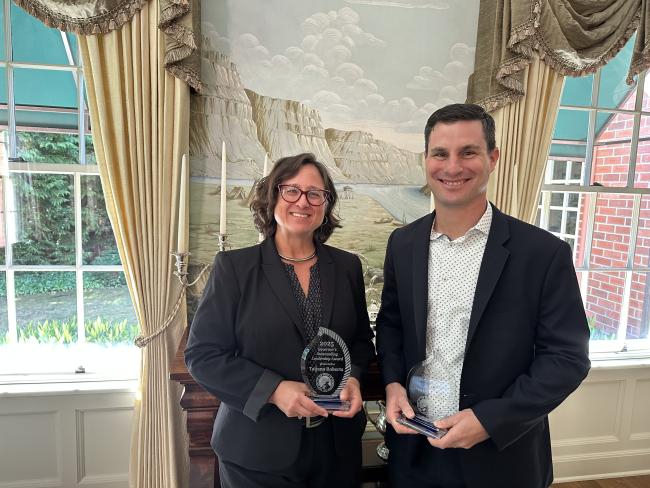 ESD staff Tatjana Roberts and Dan Zeitlin show off their Governor's Outstanding Leadership Awards.